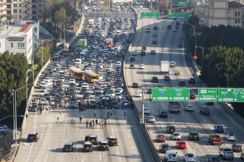 LOS ANGELES, CA - DECEMBER 13: American Jews and allies block the 110 freeway in downtown on Wednesday, Dec. 13, 2023 in Los Angeles, CA to call for an Israeli ceasefire. (Myung J. Chun / Los Angeles Times)