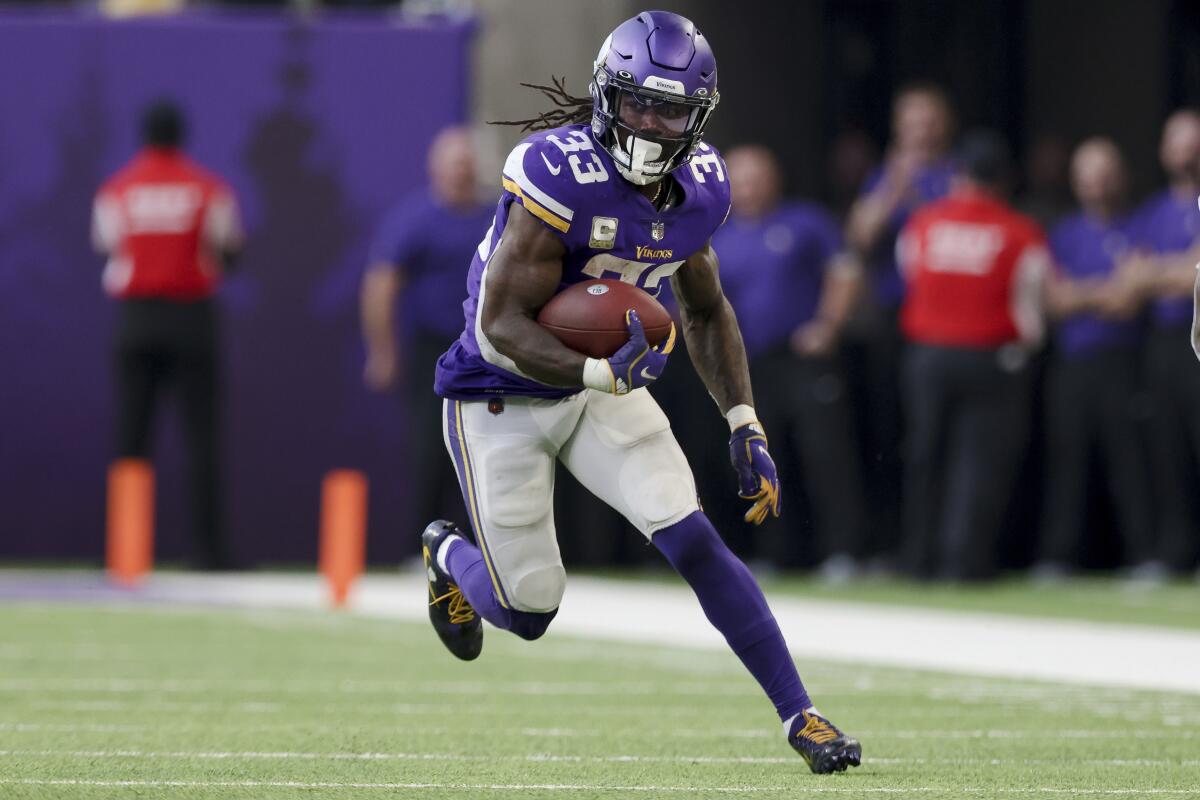 Minnesota Vikings running back Dalvin Cook carries the ball.