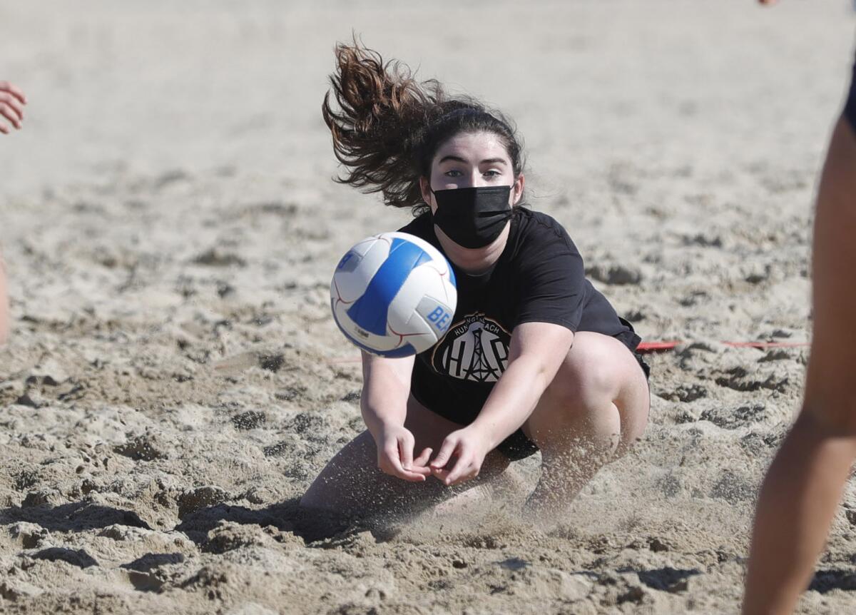 Huntington Beach libero Tori Hagan digs a ball during a beach volleyball match against Newport Harbor on March 4.