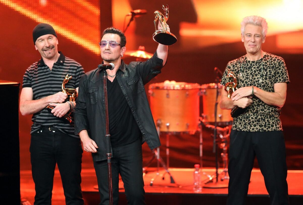 U2, with frontman Bono at center, accepts a prize in the international music category Bambi Awards in Berlin on Thursday.