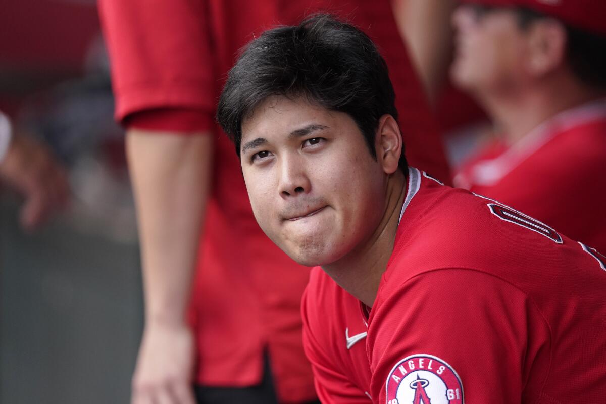 The Angels' Shohei Ohtani sits in the dugout during the first inning.