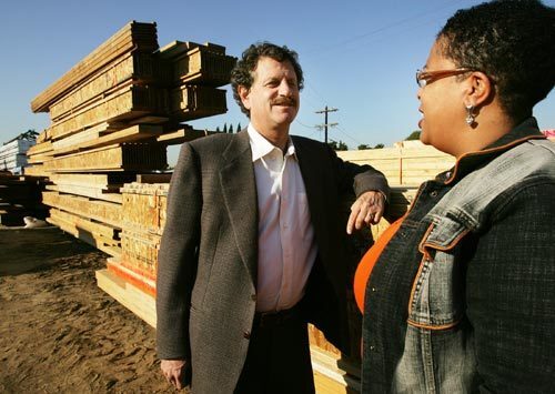 Jeff Lee, president of Lee Homes, talks with Noreen McClendon of Concerned Citizens of South Central Los Angeles at the development site in the Watts. The developer and community group believe the new homes are vital to rejuvenating one of Los Angeles' most impoverished neighborhoods.