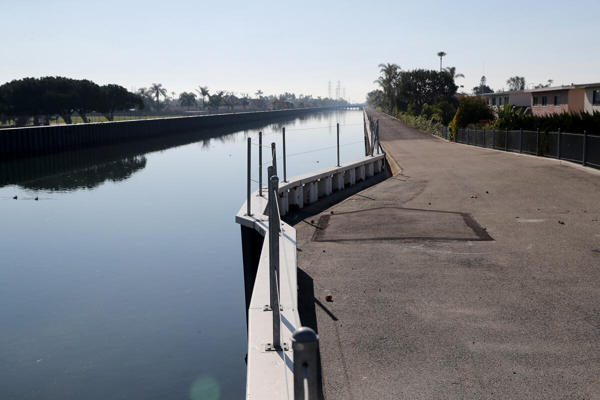 Facing south along a path on the west side of Talbert Channel by Sowers Park, left, in Huntington Beach. 