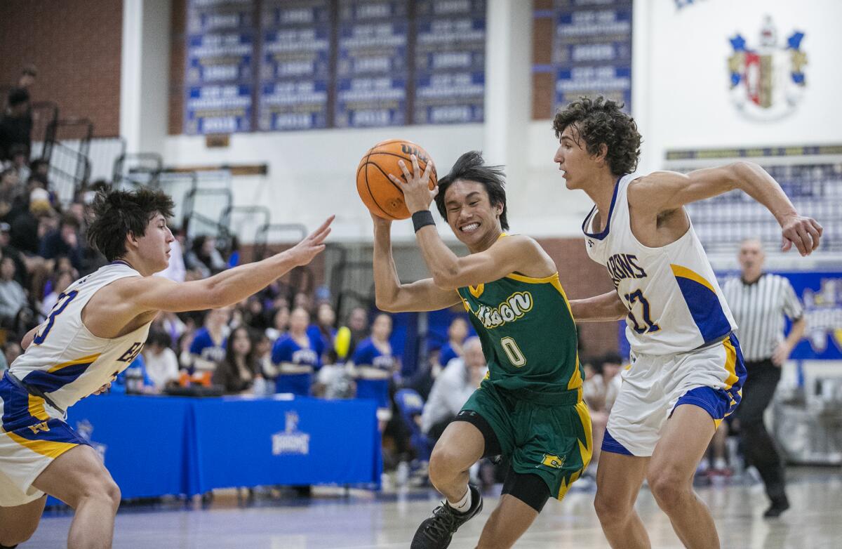 Edison's Cong-ly Tu splits Fountain Valley's defenders Troy Leach, left, and Devin Payne during Thursday's game.