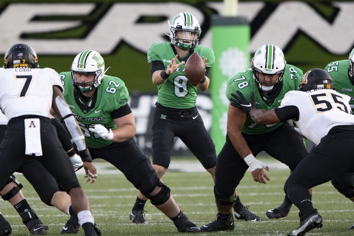 Marshall quarterback Grant Wells takes a snap during Saturday's win over Middle Tennessee.