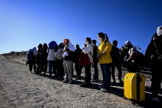 Asylum-seekers from China wait to be processed by U.S. Border Patrol agents after crossing the nearby border with Mexico, Tuesday Sept. 26, 2023, near Jacumba Hot Springs, Calif. Migrants continue to arrive to desert campsites along California's border with Mexico, as they await processing.(Photo by Denis Poroy)