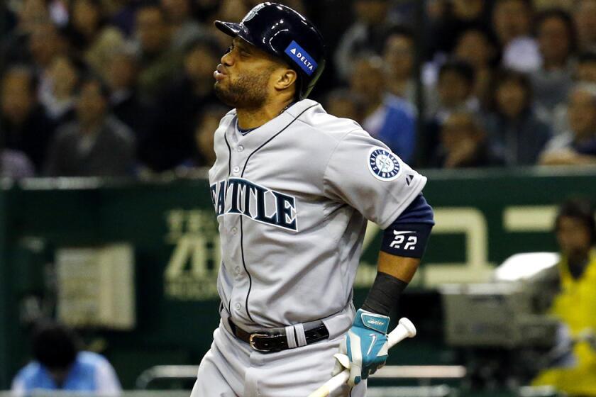 Robinson Cano grimaces after getting hit in the right foot by a pitch from Japan pitcher Yuki Nishi in the seventh inning of an All-Star baseball series in Tokyo on Saturday. X-rays showed his little toe was broken.