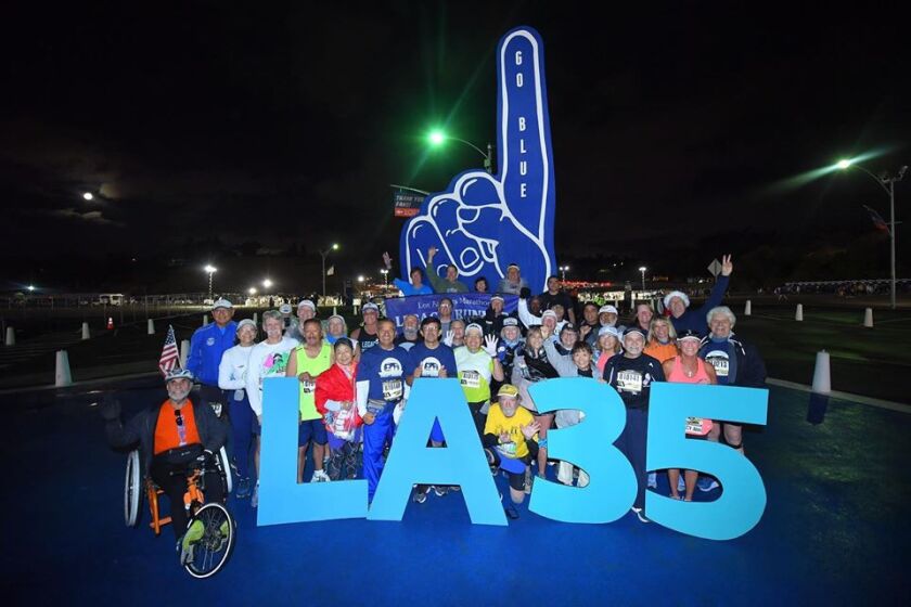 L.A. Marathon Legacy Runners celebrate their 35th Los Angeles Marathon together before the start of the race on March 8, 2020.
