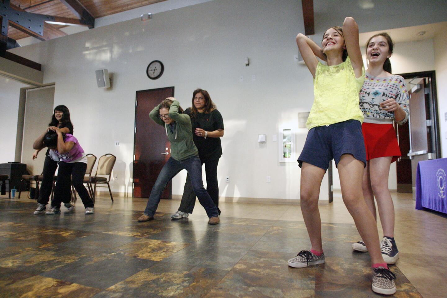 Alexandra Melkonians, 12, from left, Candice LeFranc, 11, Cassandra Pruett, Candice's mother, Ligia, Maritza Gonzalez, 12, and Dariana Peraza, 13, practice some moves during a self defense class, which took place at the Adult Recreation Center in Glendale on Wednesday, April 3, 2013. April is sexual assault awareness month. According to the U.S. Department of Justice's National Crime Victimization Survey, someone is sexually assaulted every two minutes.