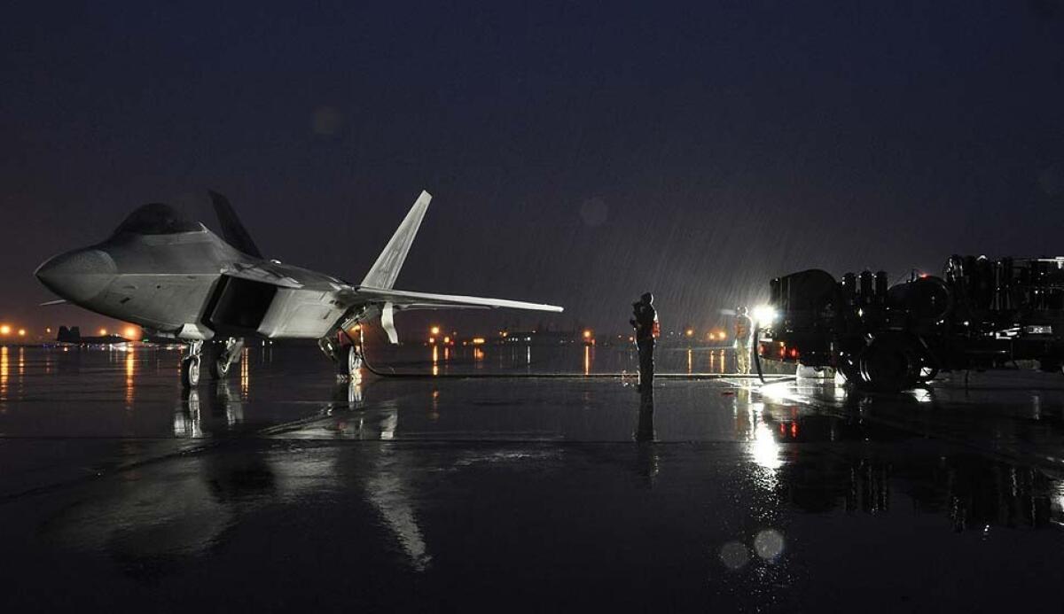 Airmen perform a hot pit refuel with an F-22 Raptor on Nov. 15, 2012, at Joint Base Elmendorf-Richardson, Alaska.