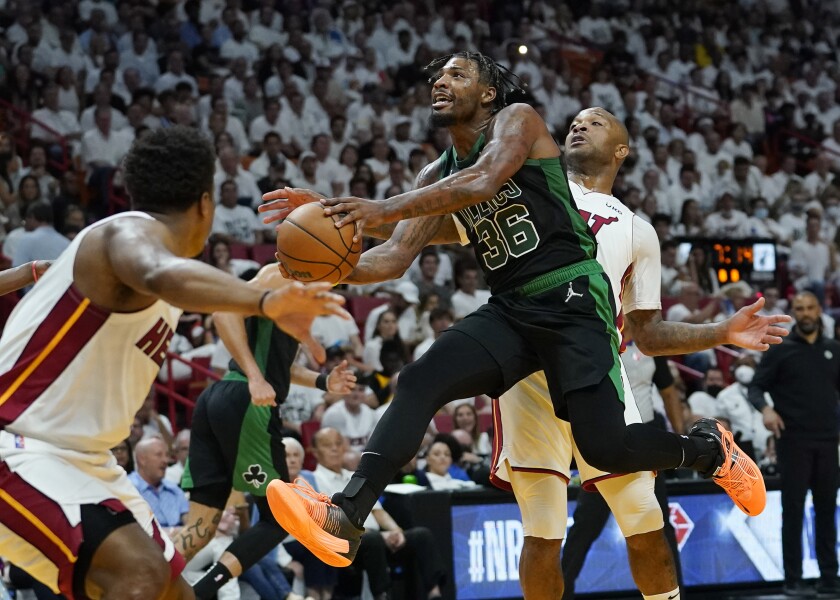 Boston Celtics guard Marcus Smart drives to the basket as Miami Heat forward P.J. Tucker defends.