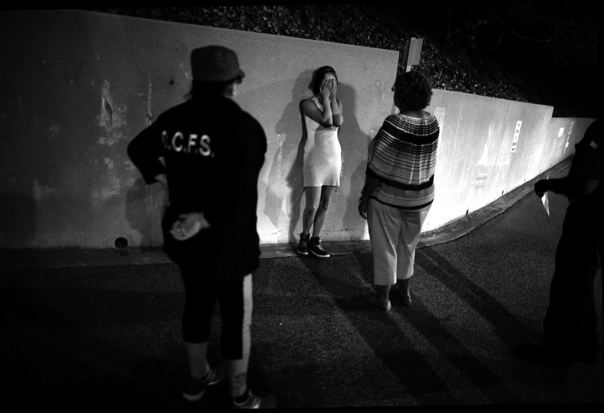 A sobbing 16-year-old yells at the social worker assigned to find her a home at a foster youth welcome center in 2015. The center is one of two that will close in the next few days.