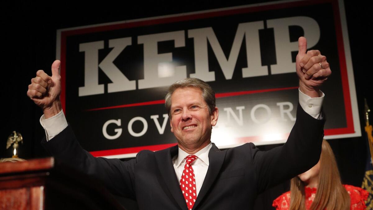 Georgia Republican gubernatorial candidate Brian Kemp gives a thumbs-up to supporters, Wednesday, Nov. 7, 2018, in Athens, Ga.