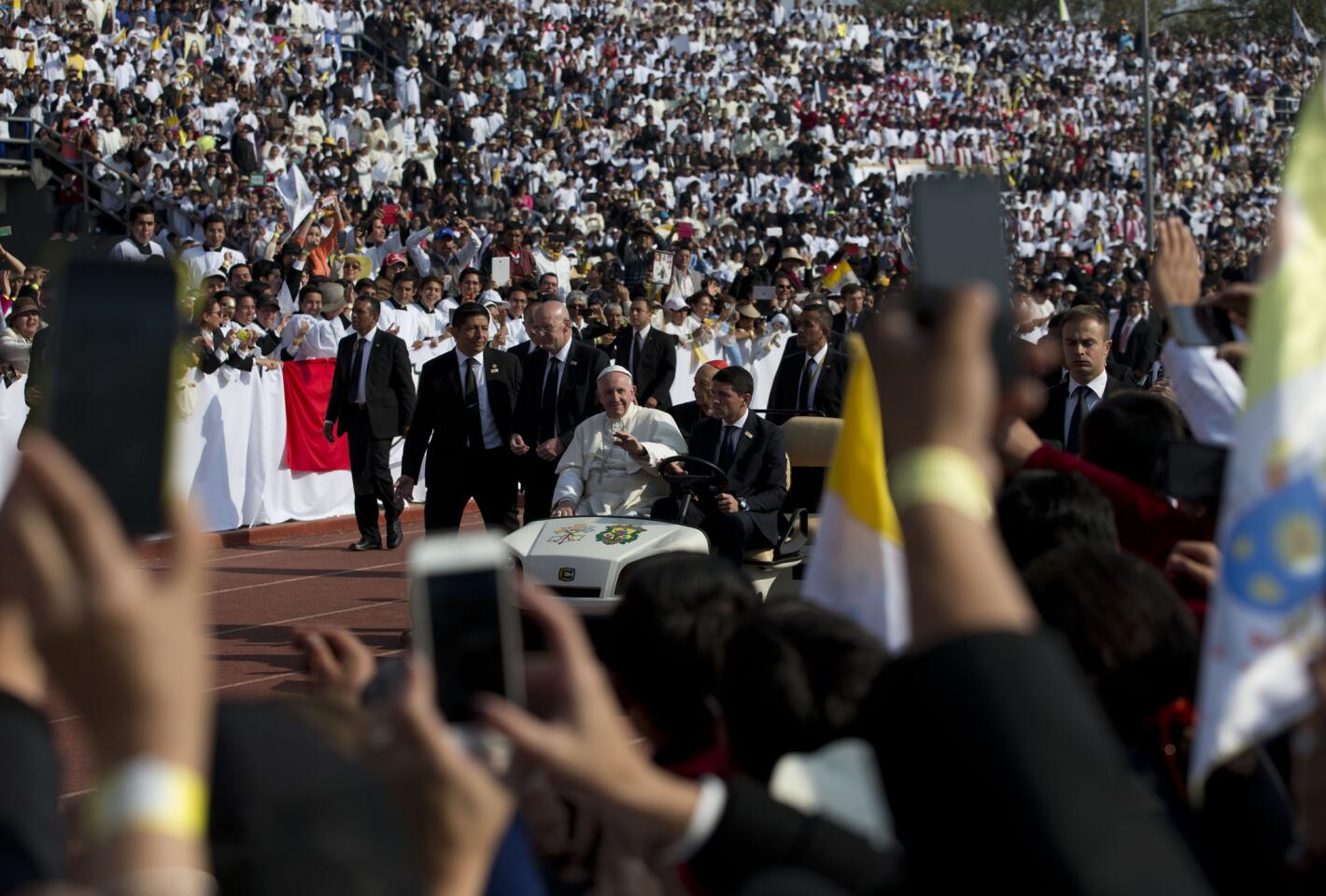 Pope Francis arrives for Mass in a golf cart at Venustiano Carranza stadium in Morelia, Mexico, Tuesday, Feb. 16, 2016.