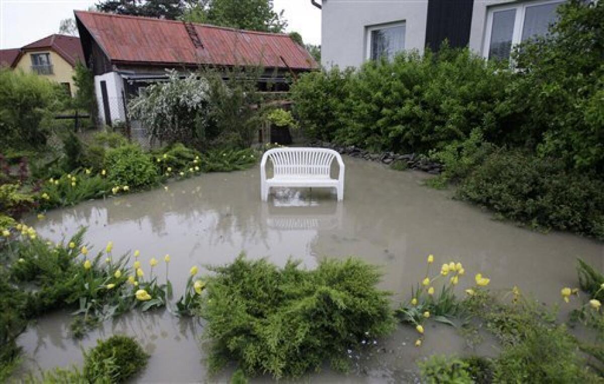 A bench is seen in front of a flooded house in Bohumin, north east Czech Republic, Tuesday, May 18, 2010. Floods, caused by days of heavy rain, swept through central Europe on Monday and Tuesday, killing at least four people and forcing the evacuation of thousands more. (AP Photo/Petr David Josek)