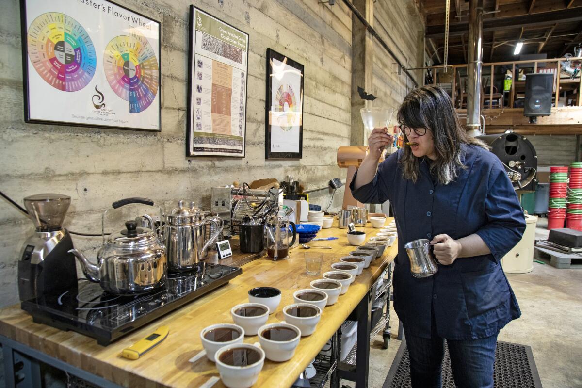 Trish Rothgeb performs the slurping test on different coffee brews during a tasting session at Wrecking Ball Coffee Roasters