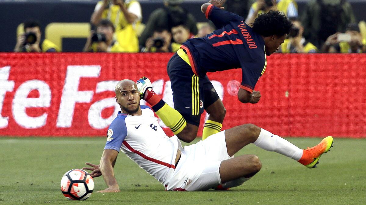 U.S. defender John Brooks makes a slide tackle to take the ball from Colombia's Juan Cuadrado during a Copa America group play game June 3.