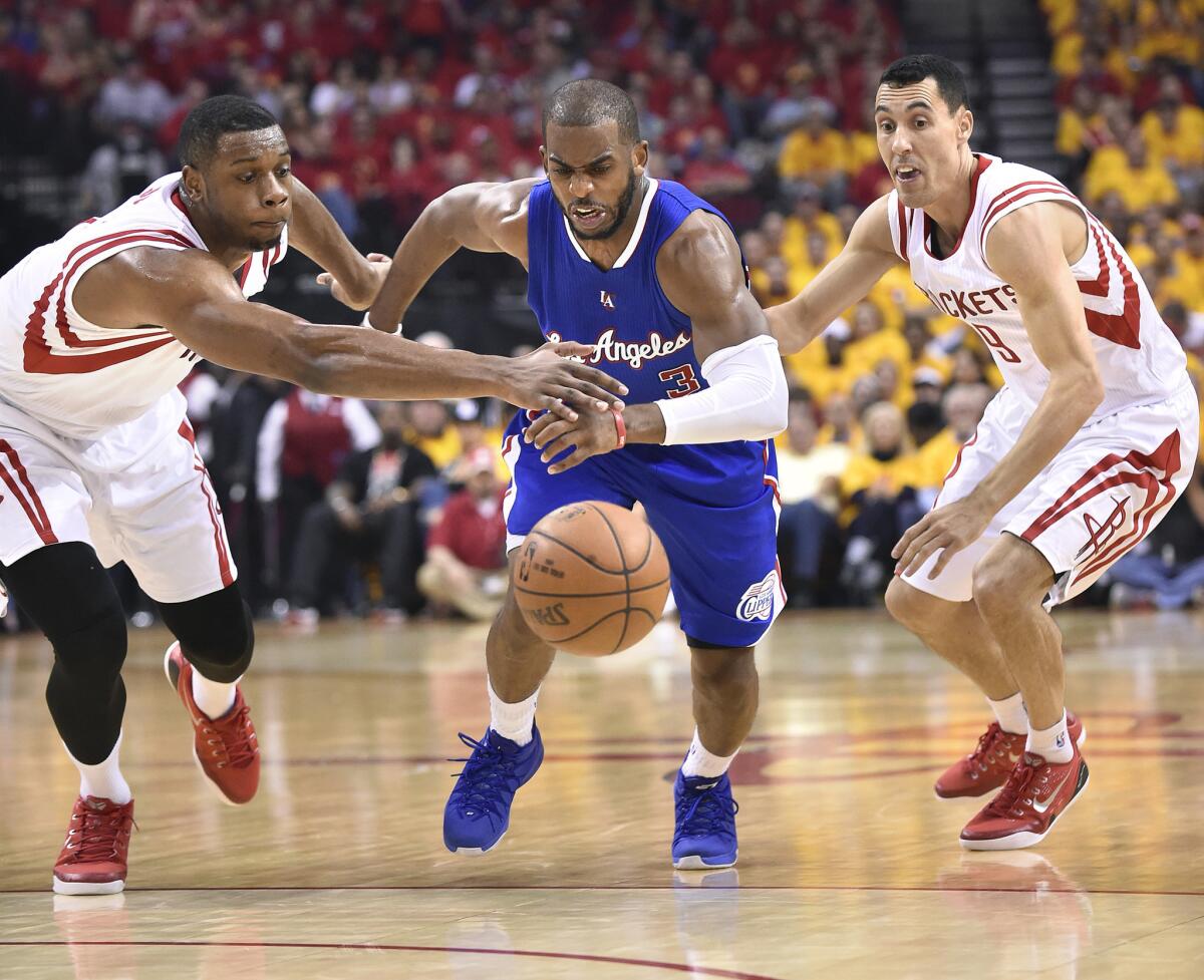 Houston guard Terrence Jones, left, knocks the ball away from Chris Paul during Game 5 of the second-round playoff series between the Clippers and the Rockets.