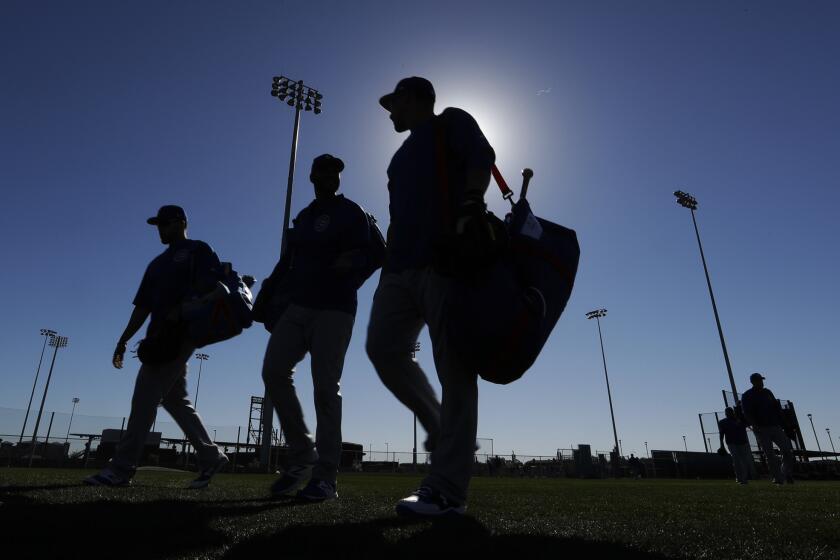 Chicago Cubs players make their way to a field during a spring training baseball workout in Mesa, Ariz., where they are preparing for their 2017 campaign as reigning World Series champions.