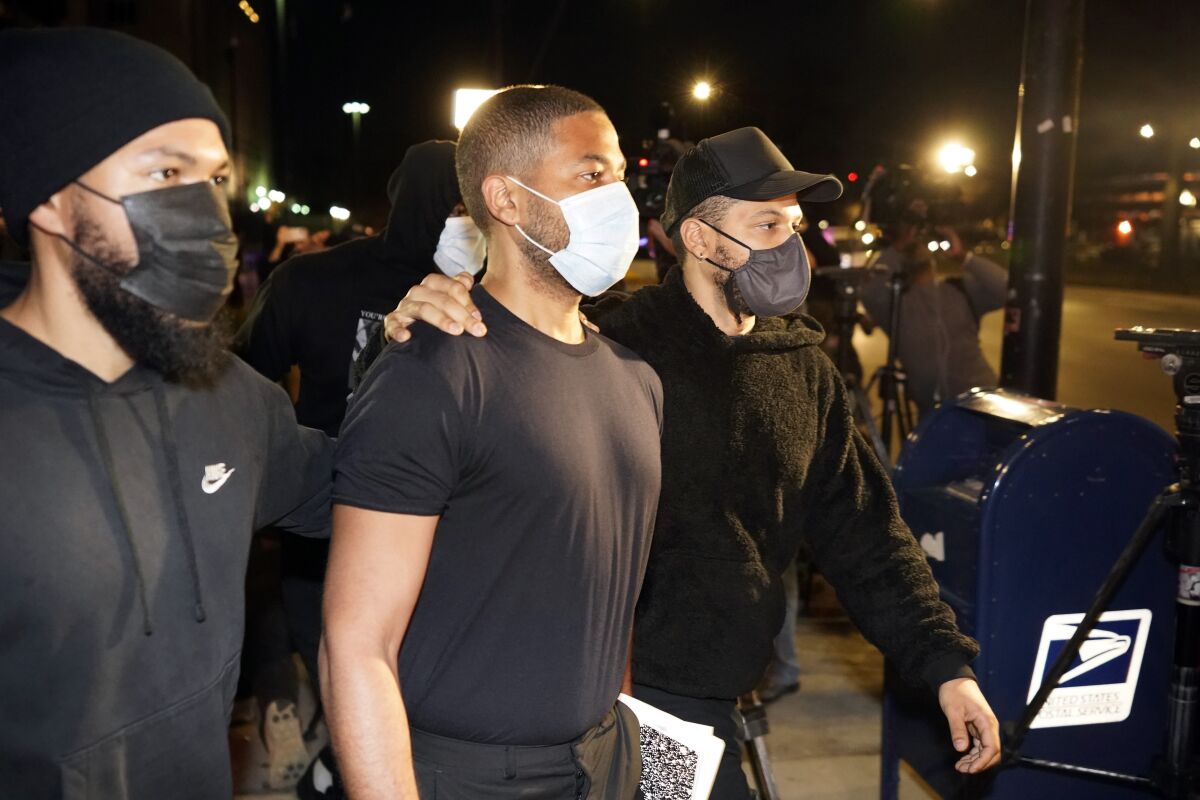 A group of men leave a jail.