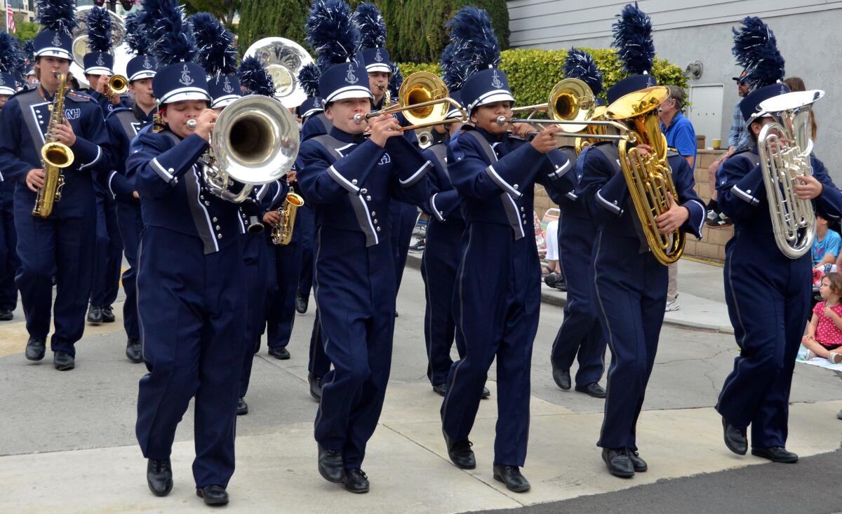 The Newport Harbor High School Marching Sailor Regiment march in the parade.