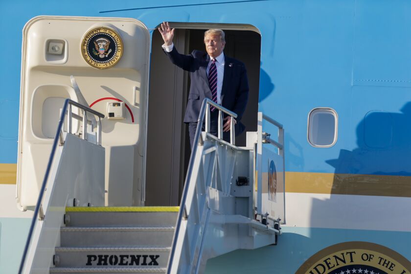 Los Angeles, CA., February 17, 2020 —President, Donald Trump waves at onlookers as he departs Air Force One at LAX on his visit to Los Angeles, California on Monday, February 17, 2020. (Jason Armond / Los Angeles Times)