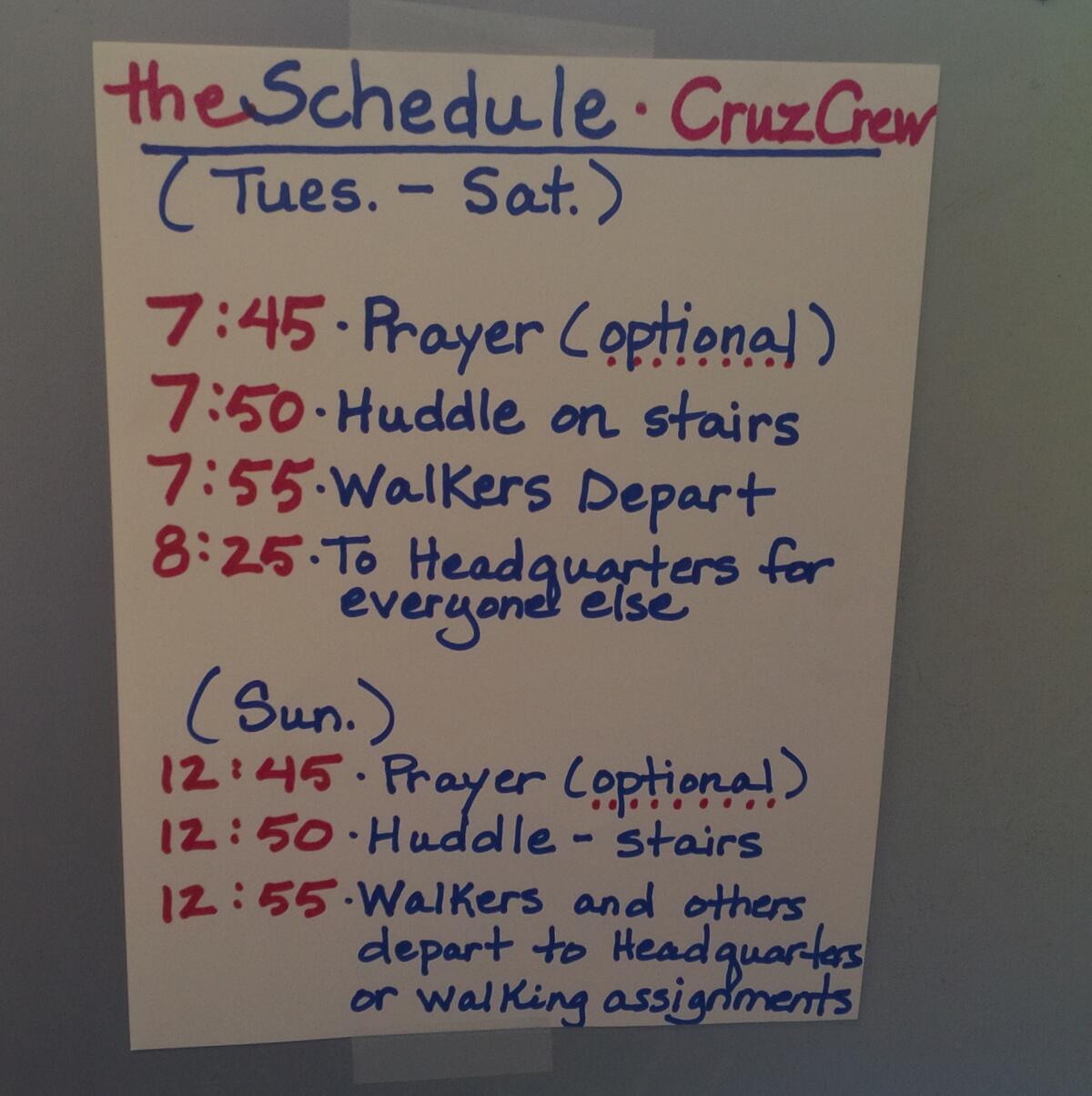 A schedule is posted on a doorway at "Camp Cruz" in Des Moines, where volunteers from around the country are living at an old college dormitory.