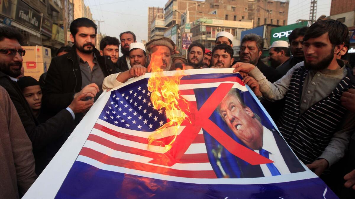 In this photo from Jan. 5, protesters in Peshawar, Pakistan, take to the streets to express anger over the U.S. decision to suspend aid.