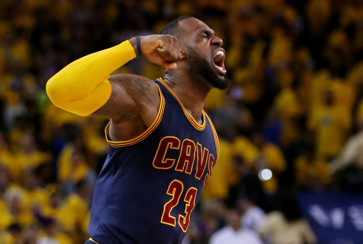 Forward LeBron James celebrates after the Cavaliers toppled the Warriors, 95-93 in overtime, in Game 2 of the NBA Finals on Sunday night in Oakland.