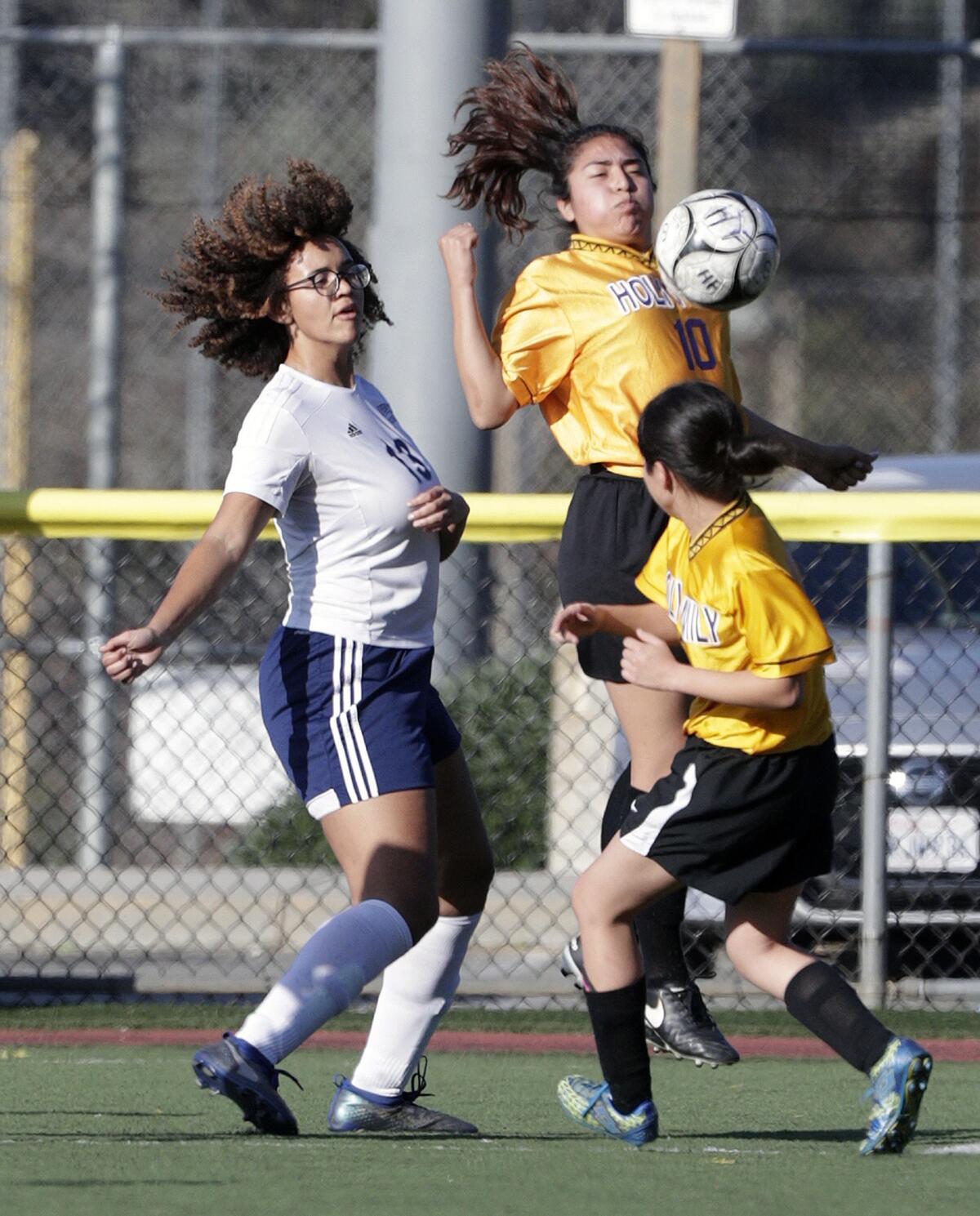 Holy Family's Samantha Martinez chest traps the ball against Alverno Heights' Afton Okwu in a Horizon League girls' soccer game at the Glendale Sports Complex in Glendale on Monday, January 27, 2020.