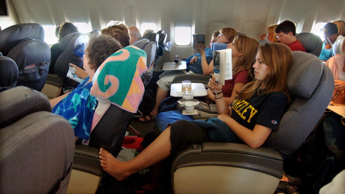 Business-class fliers on a United Airlines flight to Hawaii in 2011. Most fliers say passengers on commercial flights should dress appropriately for a flight.