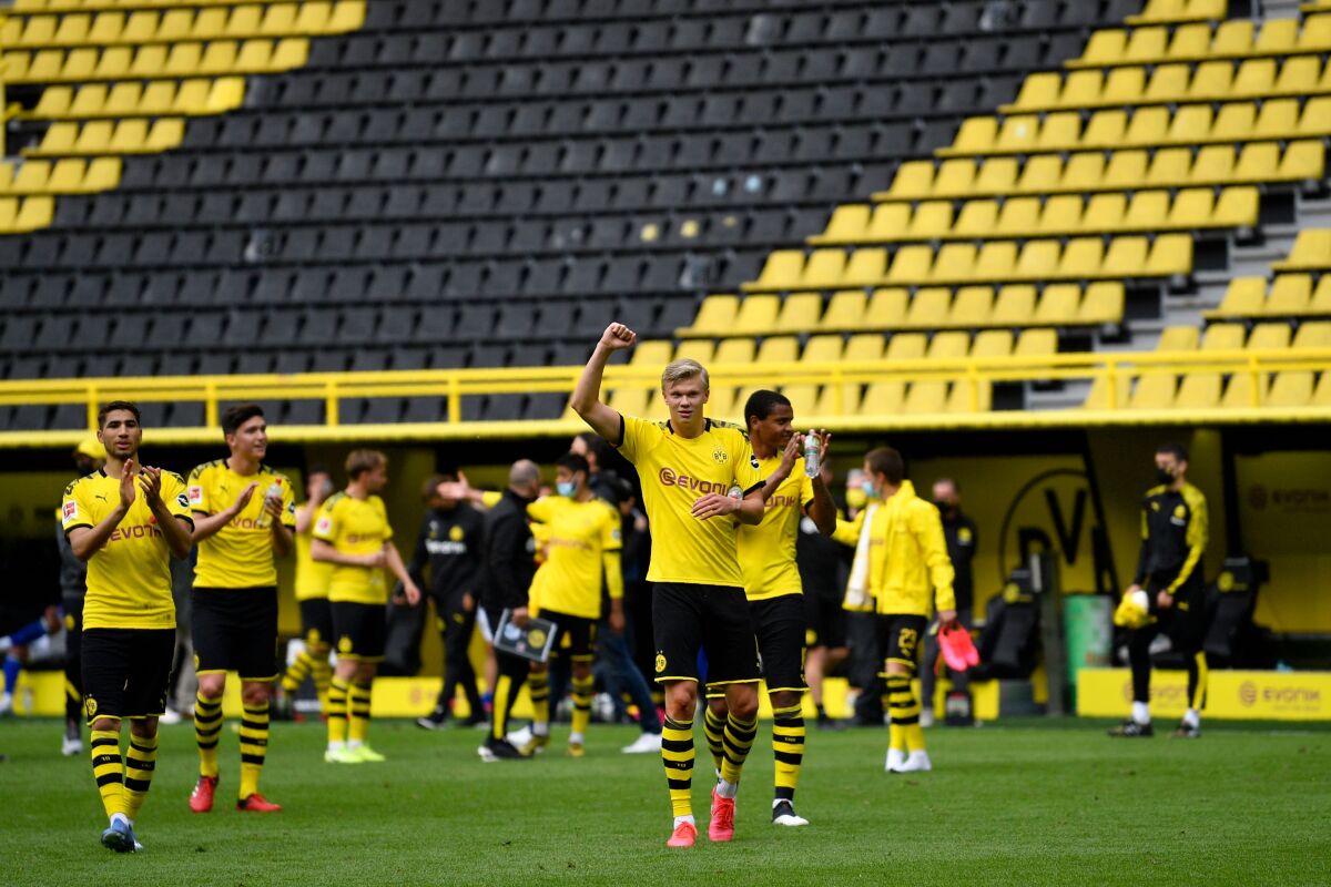 Borussia Dortmund's Erling Haaland, center, and his teammates celebrate winning the German Bundesliga soccer match between Dortmund and Schalke in Dortmund, Germany, on Saturday.