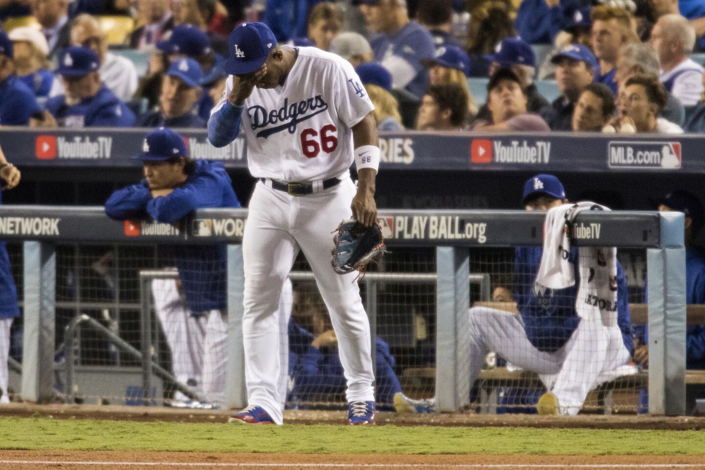 Yasiel Puig heads to the outfield in the ninth inning.