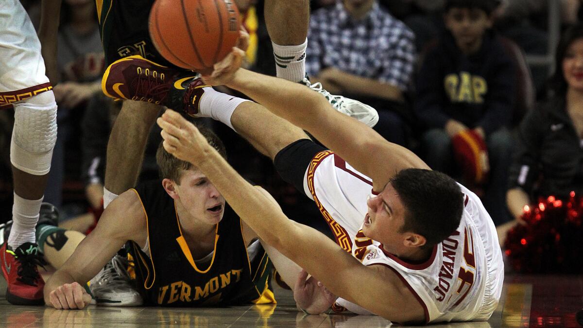 USC's Nikola Jovanovic, right, recovers a loose ball after stealing it from Vermont's Kurt Steidl during the first half of the Trojans' 64-56 win at Galen Center on Tuesday.