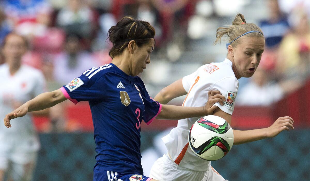 Japan's Azusa Iwashimizu fights for control of the ball with Netherlands' Vivianne Miedema during the first half of a FIFA Women's World Cup quaterfinal match on Tuesday.