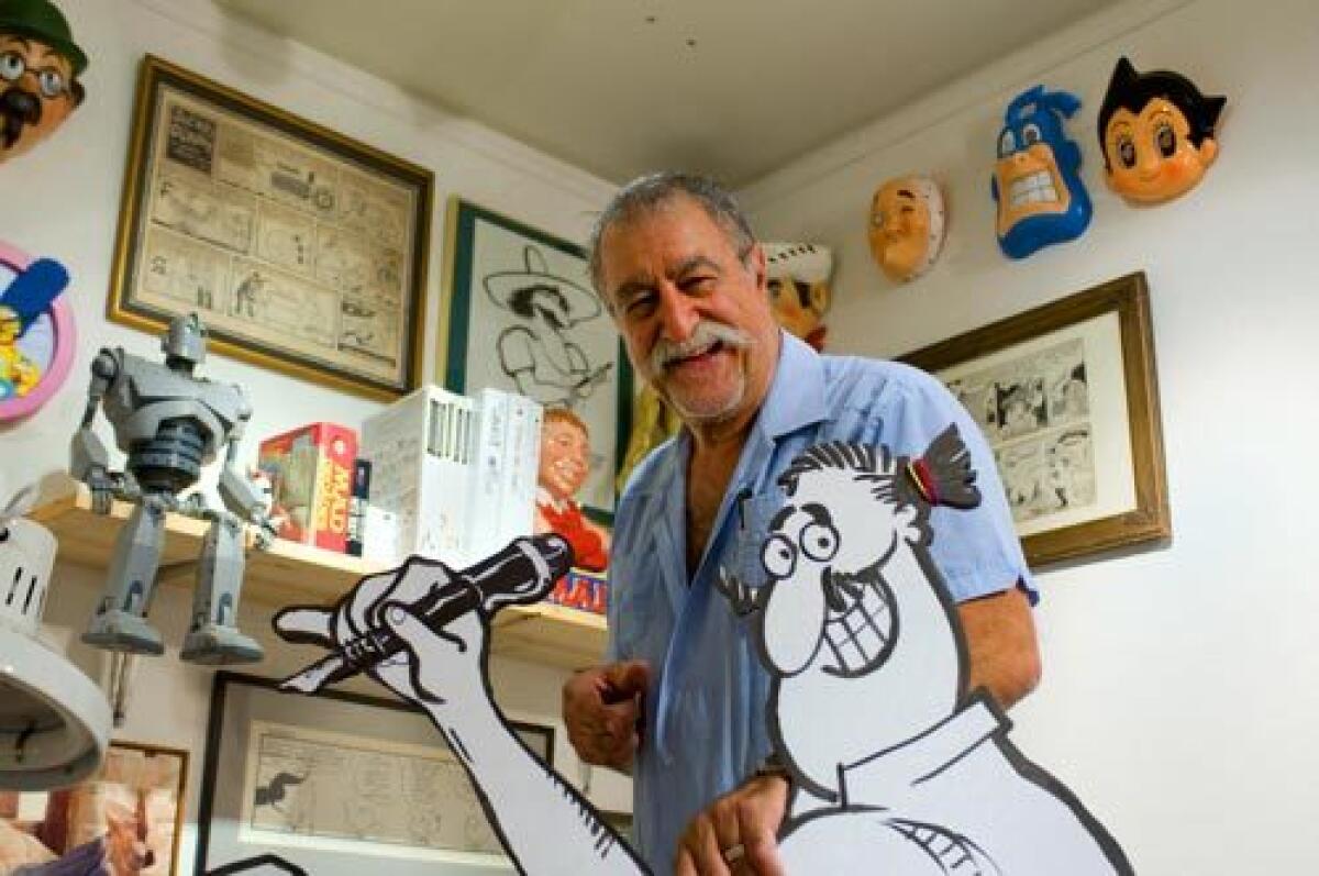 Cartoonist Sergio Aragonés poses with his self-portrait at the Ojai Valley Museum, whose "Mad About Sergio" exhibition runs through Oct. 4.