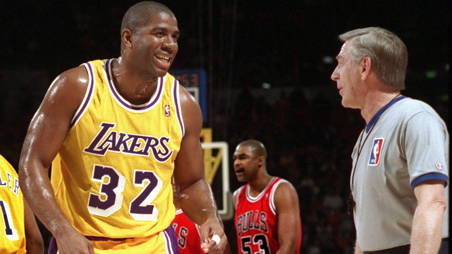 Lakers star Magic Johnson speaks with a referee during a game against the Chicago Bulls on Feb. 12, 1996.