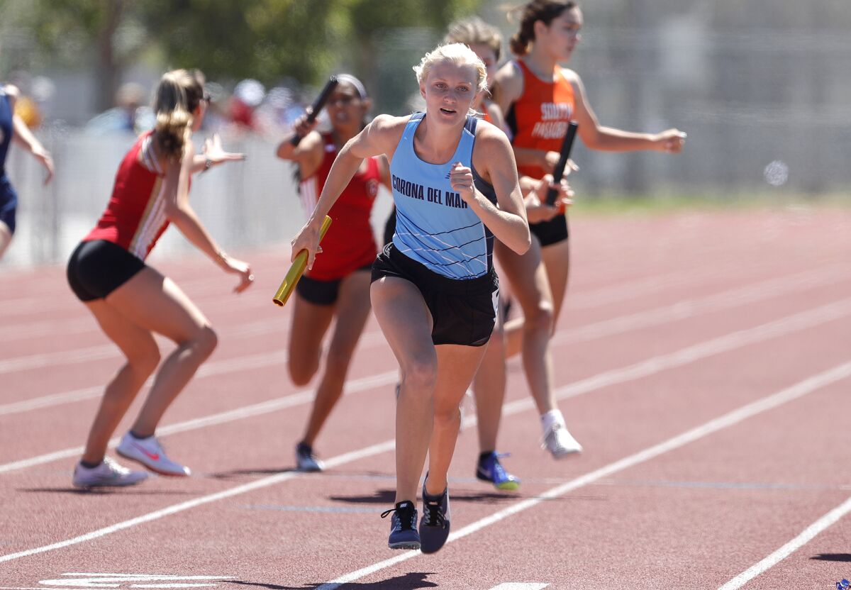 Coco Chinnici of Corona del Mar begins to sprint after taking the baton during the girls' 400 relay.