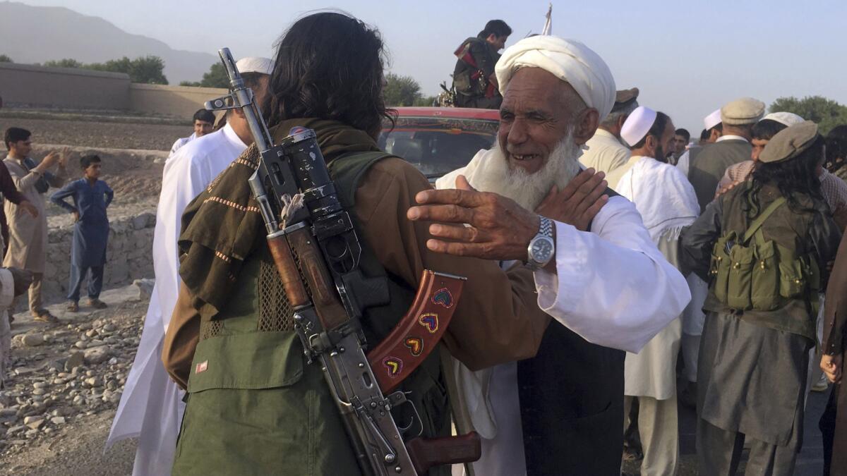 Taliban fighters and others celebrate a three-day cease-fire marking the Islamic holiday of Eid al Fitr in Afghanistan's Nangarhar province on June 16.