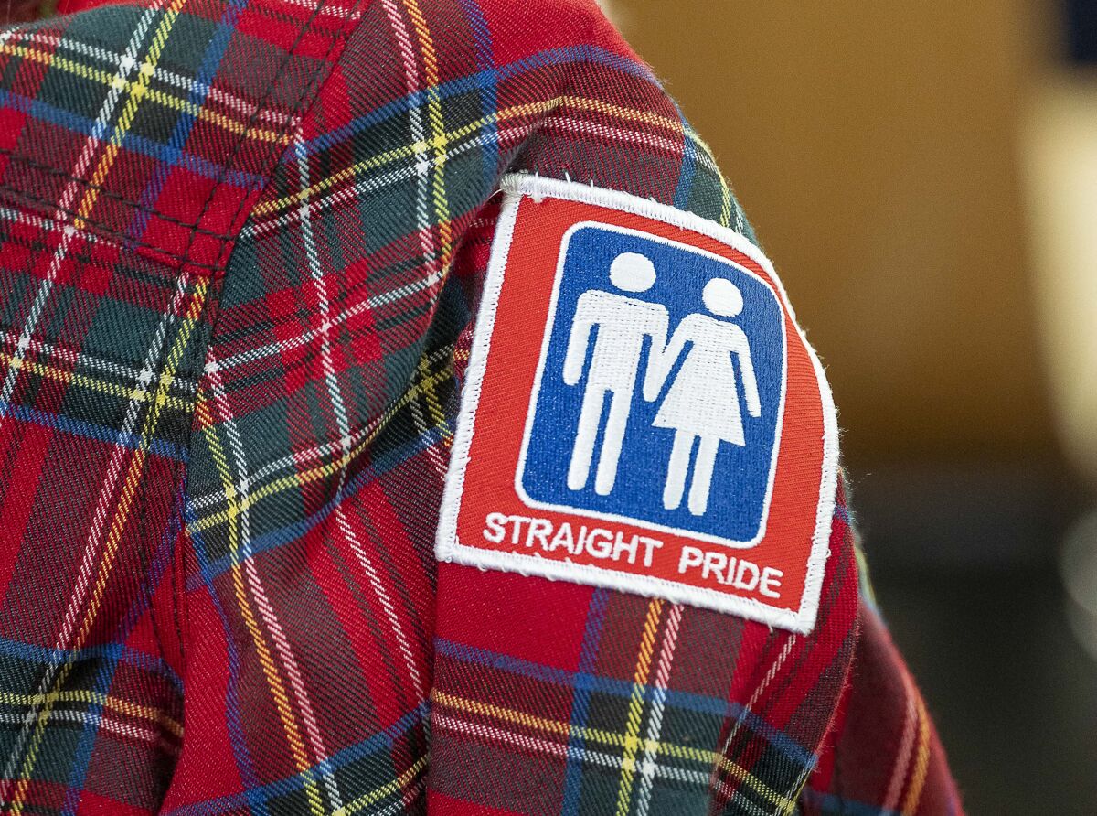 A "straight pride" patch is seen on a supporter's shirt during a rally