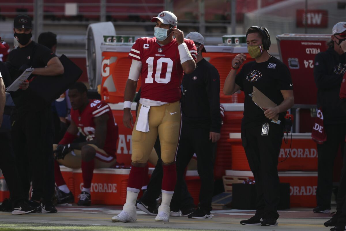 San Francisco 49ers quarterback Jimmy Garoppolo (10) stands on the sideline during the second half of an NFL football game against the Miami Dolphins in Santa Clara, Calif., Sunday, Oct. 11, 2020. (AP Photo/Jed Jacobsohn)