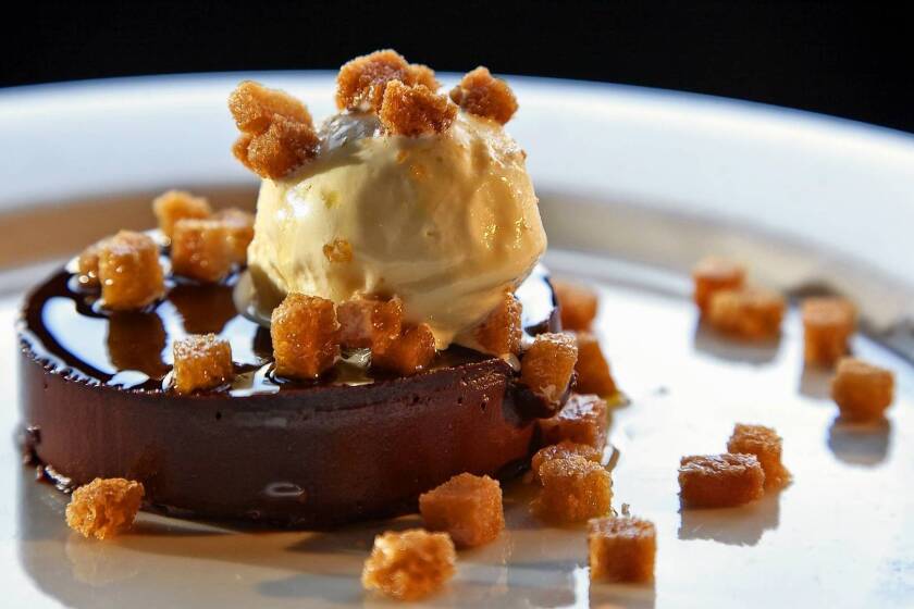 The bittersweet chocolate tartufo is capped with olive oil gelato and sprinkled with olive oil-fried croutons.