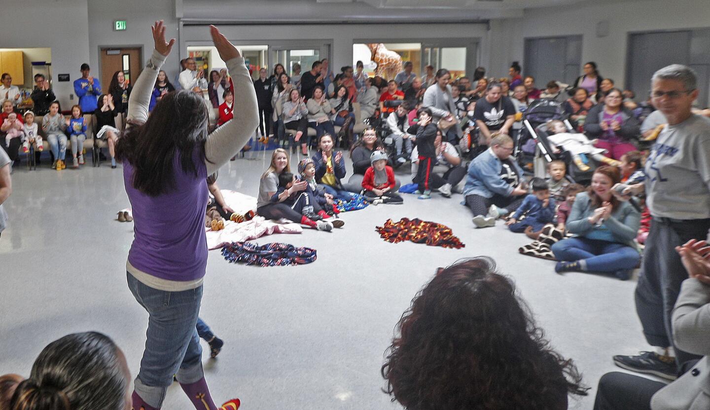 College View Principal Jay Schwartz raises her hands in excitement after the record of 122 giraffe socks was broken at College View School in Glendale on Friday, January 18, 2019. 166 or more, depending on anybody who wasn't counted yet, were in attendance wearing giraffe socks, including GUSD school board members, the Glendale Police Department, several other representatives, and parents, students and faculty. Regardless of the final number, the goal was to beat last year's number of 122, which they did.