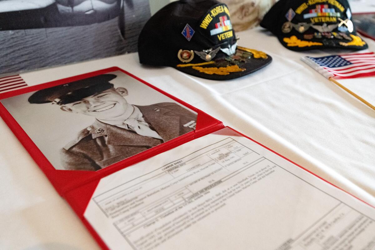 A photo of Major Billy Hall alongside documents charging him with joining the military with false information.