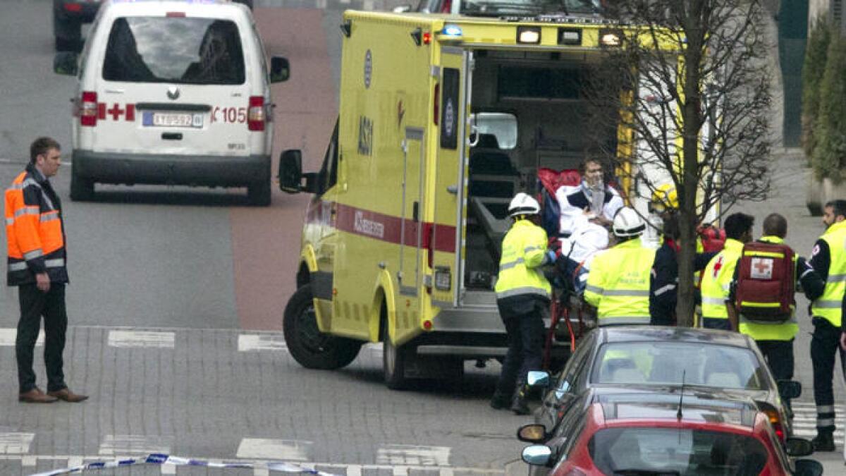 A woman is evacuated after an explosion in a Brussels metro station Tuesday.