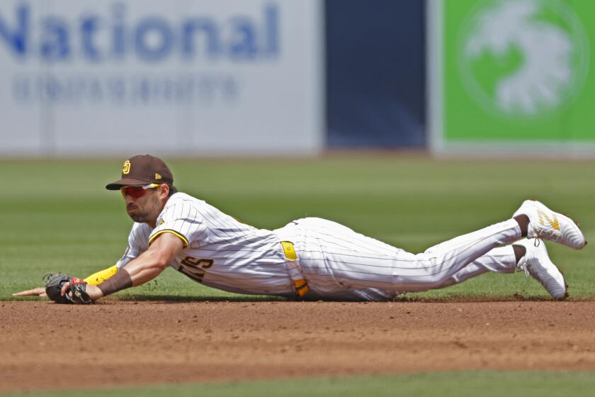 San Diego CA - May: San Diego Padres' Tyler Wade makes a diving catch on a line drive by Cincinnati Reds' Santiago Espinal in the second inning at Petco Park on Wednesday, May 1, 2024. (K.C. Alfred / The San Diego Union-Tribune)