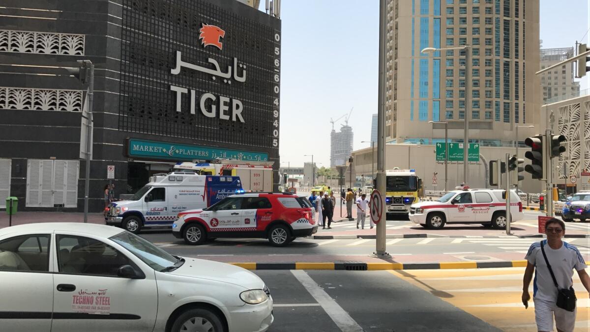 Emirati authorities close the road in front of the Tiger Tower after a fire broke out on the building's 53rd floor.