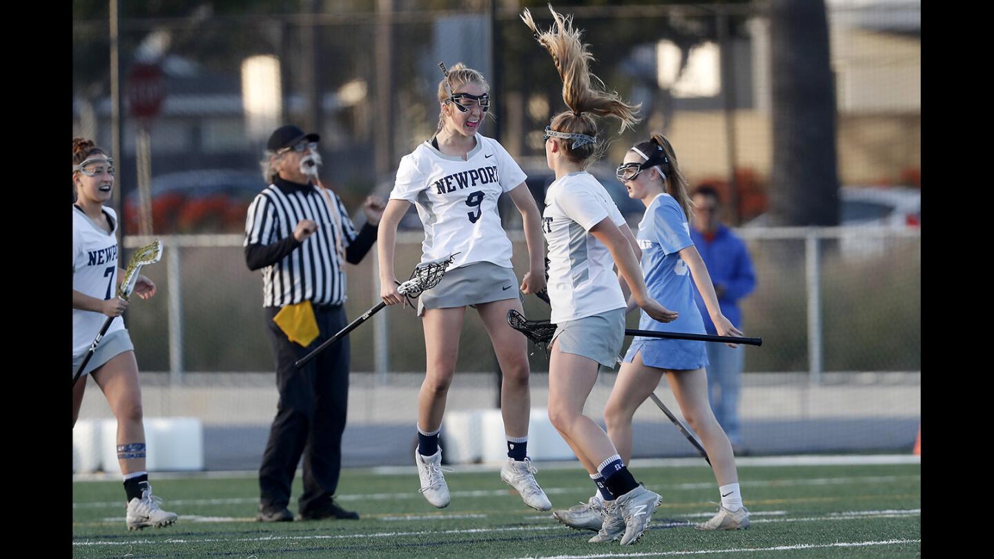 Newport Harbor High's Reese Vickers, center, and Joelle Rothbard, right, celebrate after Vickers assisted on Rothbard's goal during the first half against Corona del Mar in a Sunset League game at Newport Harbor on Thursday.