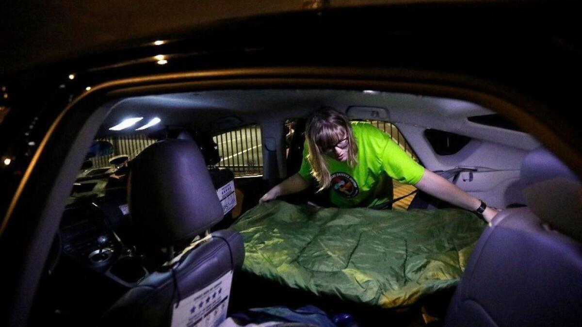 At 1 a.m. Jos Cashone, 28, works on social media to promote a one-day strike against Uber and Lyft before bedding down for the night in her car.
