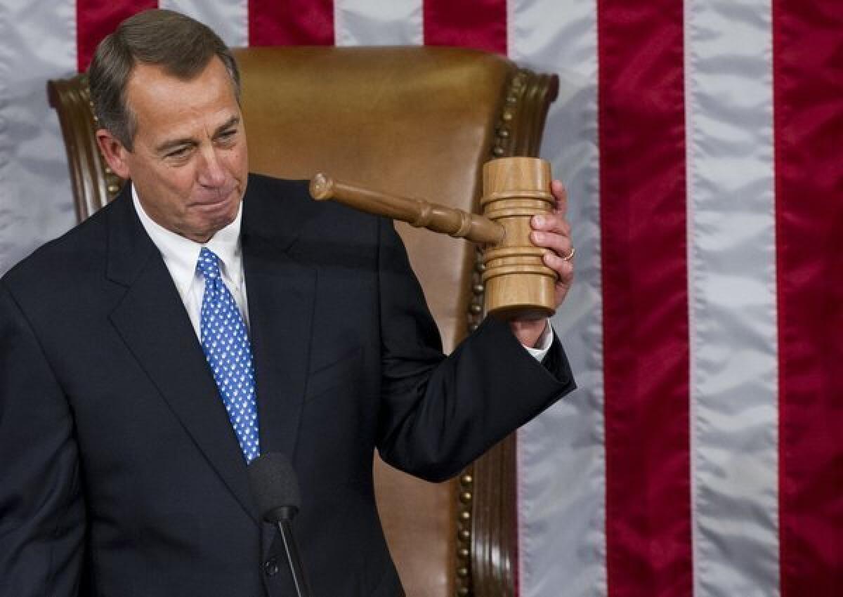 Speaker of the House John Boehner, holds up his gavel after being re-elected as Speaker of the House during the opening session of the 113th House of Representatives.